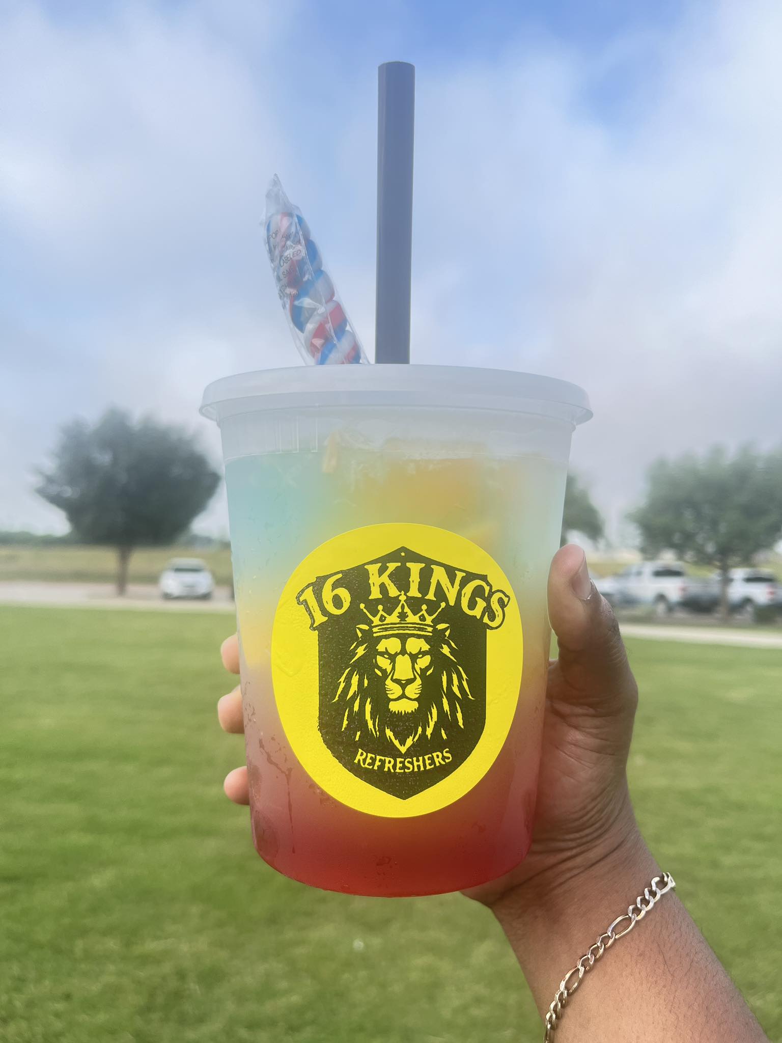 Hand holding a refreshing 16 Kings lemonade